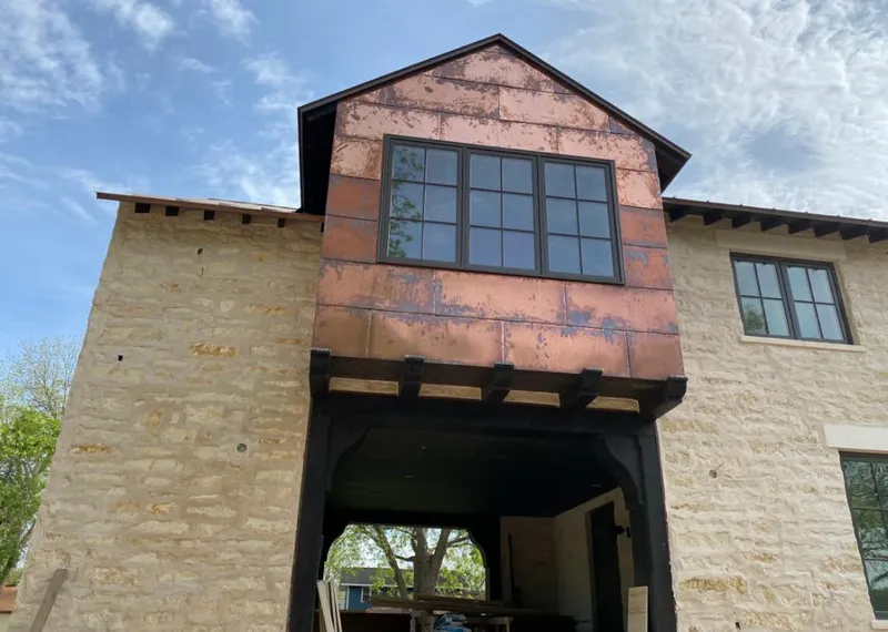 Copper metal panel facade on a stone building for Skylight Installation in Calimesa